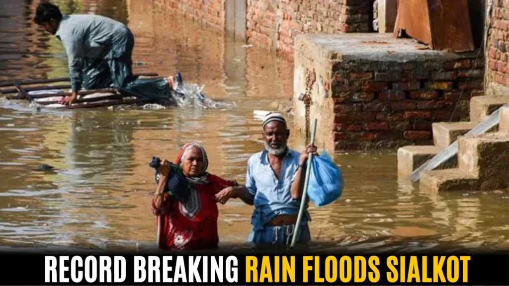 People struggle through high water during record breaking rain floods Sialkot, showing severe damage and urgent rescue needs.