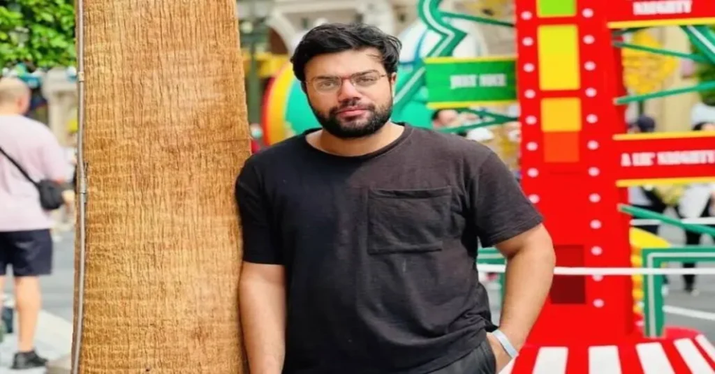 Ducky Bhai standing outdoors in casual clothes amid colorful surroundings – Ducky Bhai Case Update Today photo.