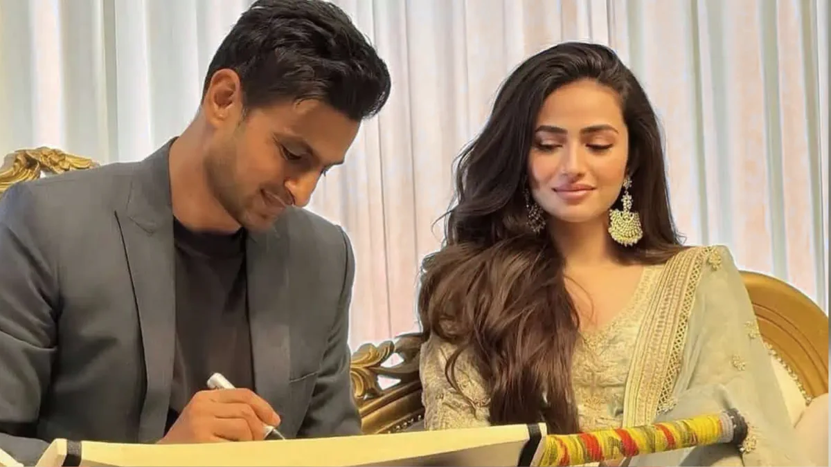 Shoaib Malik and Sana Javed Divorce — couple seen during their wedding ceremony signing papers, dressed in elegant traditional attire.